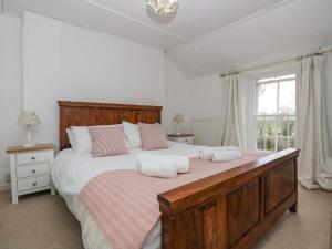 a bedroom with a large bed with two pillows on it at Little Chycoose in Truro