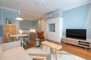 a living room with a couch and a tv at Blau 1911 in Porto