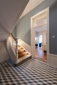 a staircase in a house with a checkered floor at Blau 1911 in Porto