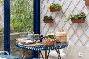 a table with food and flowers on a patio at Blau 1911 in Porto