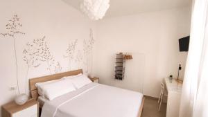 Postel nebo postele na pokoji v ubytování B&B Le Albarelle