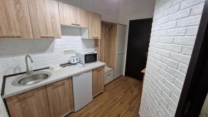 a small kitchen with a sink and a microwave at НИК аэро in Kharkiv