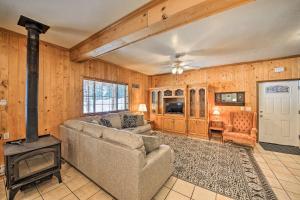 a living room with a couch and a stove at Family-Friendly Sagle Vacation Rental with Deck in Sagle