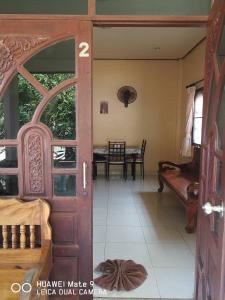 an open door to a room with a table at Thongplu Beach Resort Samui in Ban Thong Phlu