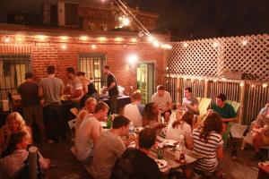a group of people sitting at tables in a restaurant at Duo Housing in Washington, D.C.