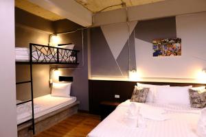 a room with two beds and a bunk bed at Room2u in Hat Yai