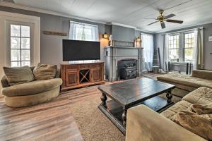 a living room with a television and a fireplace at Forestport Home with Access to Otter Lake in Forestport
