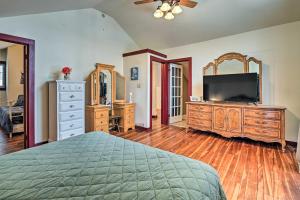 a bedroom with a bed and a dresser with a television at Forestport Home with Access to Otter Lake in Forestport