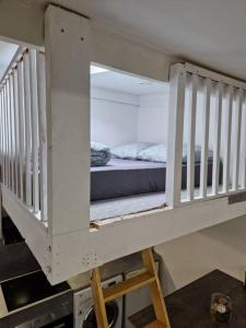 a white bunk bed in a room with a bed at maison individuelle à Drancy in Drancy
