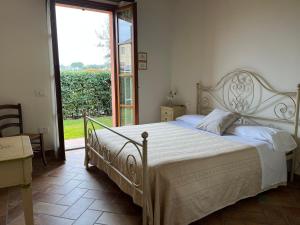 ein Schlafzimmer mit einem großen Bett und einem großen Fenster in der Unterkunft Valle del Metauro Country House in Montemaggiore al Metauro