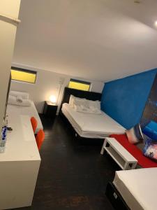 a small room with two beds and a desk at Galaxy Pods @ Chinatown in Singapore