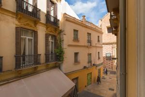 a view from a window of a street with buildings at Balcón de San Juan in Málaga