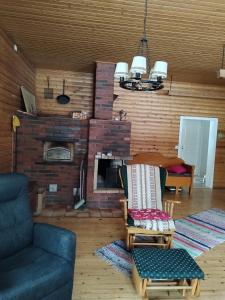 a living room with a couch and a fireplace at Granny´s House Kuusela in Portimo