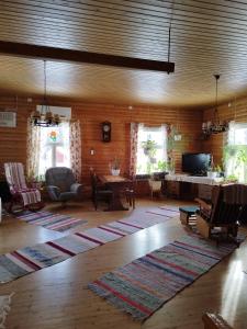 a living room with a large rug on the floor at Granny´s House Kuusela in Portimo