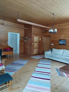 a living room with a white couch and a wooden ceiling at Granny´s House Kuusela in Portimo