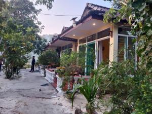 a house with a person standing outside of it at Sok San Villa Koh Rong in Phumĭ Kaôh Rŏng