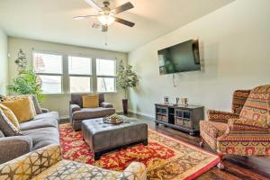 a living room with furniture and a flat screen tv at San Antonio Vacation Rental with Hot Tub, Yard! in Selma