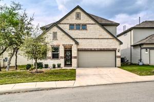 a white brick house with a garage at San Antonio Vacation Rental with Hot Tub, Yard! in Selma