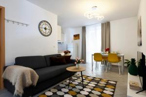 a living room with a couch and a table at Aria Apartment - Free Parking in Bioggio