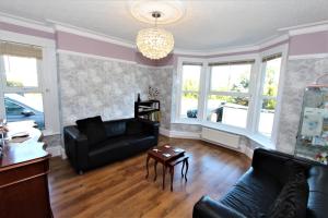 a living room with a couch and a table at Fern Howe Guest House in Keswick