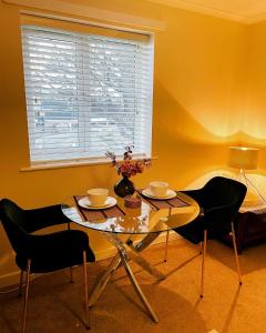 a dining room with a table and chairs and a window at Two Double bedrooms apartment near Hull city centre in Hull