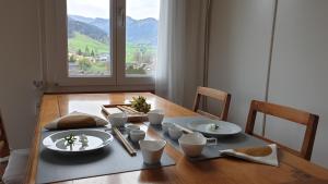 a dining room table with a view of a mountain at Haus an sonniger Lage, schöner Blick auf Alpstein in Urnäsch