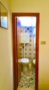 a bathroom with a toilet in a room at Hotel Alessi** Rimini in Rimini