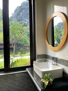 a bathroom with a sink and a mirror at Trang an green river homestay in Ninh Binh