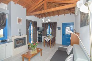 a living room with a couch and a fireplace at Samian Thalia Apartment in Pagóndas