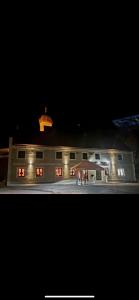 a building at night with lights on at Hotel Pame Grill in Eching