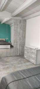 a bedroom with a bed and a dresser and mirror at Villa Giasi in Floridia