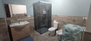 a bathroom with a shower and a toilet and a sink at Villa Giasi in Floridia +29 photos