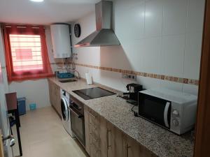 a kitchen with a sink and a stove at Apartamento Murcia in Murcia