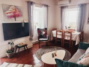 a living room with a couch and a table at Fairytale in Boïkátika