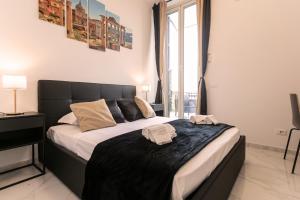 a bedroom with a large bed with two towels on it at Re di Roma Rooftop in Rome