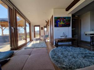 a living room with a couch and a table at Luxury Reed House in Balatonudvari
