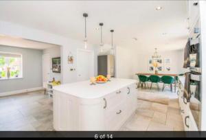 a kitchen with a white counter and a dining room at Luxury Tydd St Giles Holiday Rental in Tydd Saint Giles