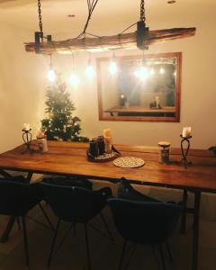 a dining room table with a christmas tree and a mirror at Luxury Tydd St Giles Holiday Rental in Tydd Saint Giles