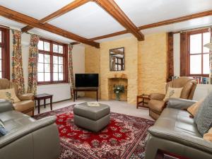 a living room with a couch and a tv at The Old Rectory in Presteigne