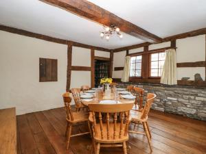 a dining room with a table and wooden floors at The Old Rectory in Presteigne