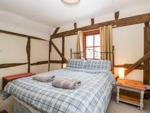 a bedroom with a bed with two towels on it at The Old Rectory in Presteigne