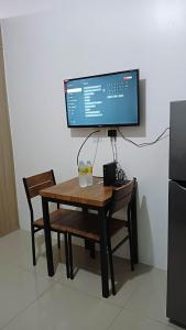 a computer monitor sitting on top of a wooden table at SHORE RESIDENCE D7 NEAR MALL OF ASIA & AIRPORT in Manila