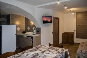 a kitchen with a table and a kitchen with a table and a kitchen at bbcascata in Bocenago