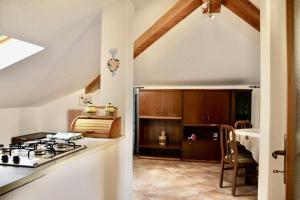 a kitchen with a stove and a counter top at CASA FIORITA in Predaia