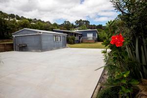 a large concrete driveway with a house in the background at Nigel's Crib - Coopers Beach Holiday Home in Coopers Beach