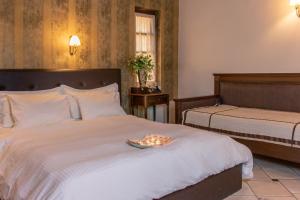 Posteľ alebo postele v izbe v ubytovaní Hagiati Anastasiou Hotel & Spa