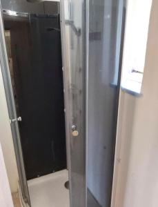 a shower with a glass door in a bathroom at Easy Backpacker Old Town in Košice