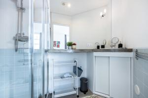 a bathroom with a shower and a sink at Perdiz do Mar in Olhão