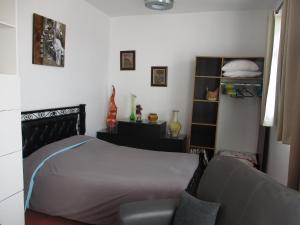 a bedroom with a bed and a chair in it at Dar Mozart in Essaouira