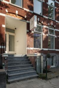 a brick building with stairs leading to a door at Hotel 171 in Rotterdam